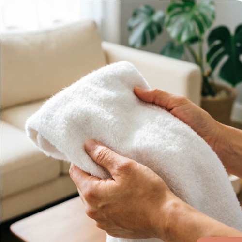 Fresh white towel being folded in a clean home
